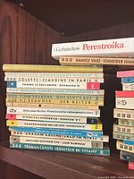 Overall view of first stack showing rororo titles (Colette, Runyon, Søberg, Branner, dtv, Baum, Capote) plus top horizontal Gorbatschow and Varè