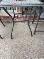 Square gray metal side table with granite top and curved legs