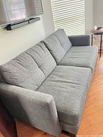 Full angled view of sofa showing overall design and fabric
