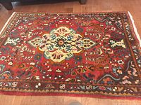 Full view of the red Persian hand-knotted rug