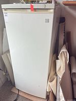 Full front view of closed Kenmore upright freezer