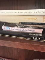 Stack of five German hardcover books showing title spines