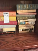 Overall view of two stacks of vintage hardcover books on shelf