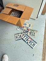 Box opened with several Texas and Ohio plates visible on floor