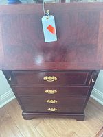front view closed desk showing four drawers, brass hardware