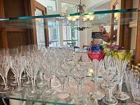 overall view of clear and coloured cut crystal stemware on shelves