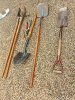 All six garden tools laid out on ground