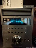 Front view of Sharp XL-BH250 main unit showing display, controls and USB port