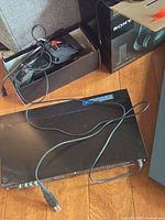 Headphones, transmitter/base, cables, retail box visible