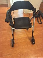 Front view showing seat, frame, wheels, and brakes