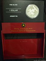 Coin in open display showing denomination and fine silver text