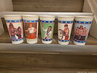 Front view of all five wrestler cups lined up