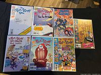 Seven bagged Ren & Stimpy comics laid out on a table