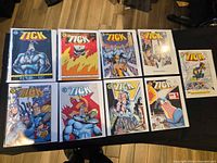 Top-down view of all ten bagged comics laid out on table