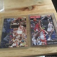 Both trading cards in plastic sleeves side by side