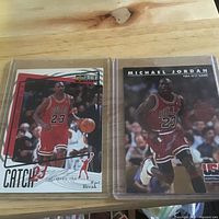 Both trading cards in protective sleeves side by side