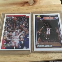 Front view of both Michael Jordan cards in sleeves