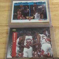 Both cards in protective holders: NBA Hoops Jordan/Malone card above, Bulls 1993-94 team card below