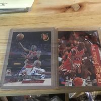 Both Michael Jordan cards in sleeves on tabletop