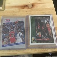 Two sleeved Michael Jordan trading cards side by side