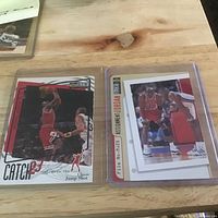 Both Michael Jordan trading cards in plastic holders on tabletop