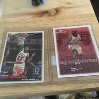 Both Michael Jordan cards in sleeves side by side