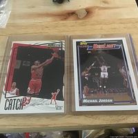 Both Michael Jordan cards in sleeves on table