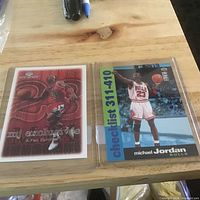 Both Michael Jordan cards in toploaders