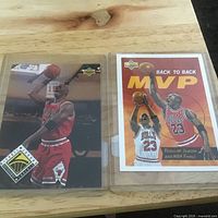 Two Michael Jordan Upper Deck cards in sleeves, MVP insert at right, Electric Court at left