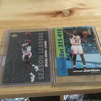 Both Upper Deck Michael Jordan cards in sleeves side by side