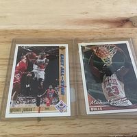 Fronts of both trading cards in sleeves