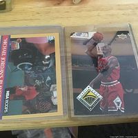 Two Michael Jordan trading cards side by side on wood surface