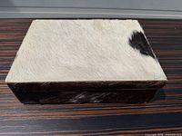 Top view showing white cowhide lid with dark patch