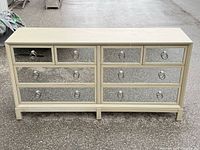 Front view of the ELTE Michael Weiss pale green 8-drawer dresser with mirrored fronts and ring pulls