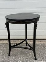 Full view of round side table showing marble top and wrought iron base