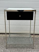 Full front view of table with clear glass shelf and white glass top