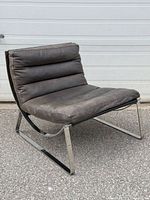 Front three-quarter view of chair showing chrome frame and leather upholstery