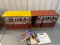 Front view of both slipcases showing DVD volumes and flyers