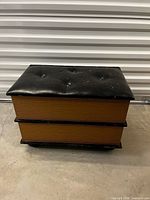 Closed ottoman showing book-style sides and black tufted lid