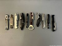 All ten bottle openers and corkscrews laid out in one row