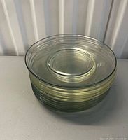 Stack of twelve clear glass salad plates
