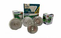 Front view of four reflector flood bulbs with corresponding Philips and SLI packaging