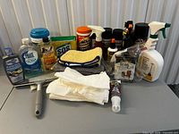 Full group shot of all cleaning supplies and tools arranged on table