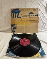 Vinyl record on inner sleeve with cardboard mailer behind