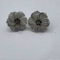 Front view of both carved mother of pearl flower studs