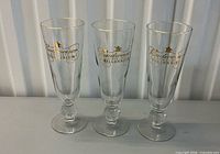 Three Budweiser Millennium pilsner glasses front view