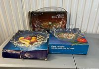 three boxed clear acrylic serving bowls on table