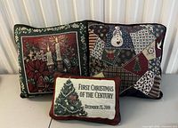 Front view of three tapestry Christmas pillows showing designs