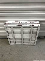 Stack of five pleated air filters front view