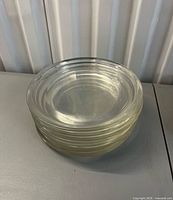 stack of six clear glass plates